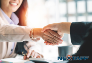 Two professionals shaking hands, NEXTAFF logo visible.